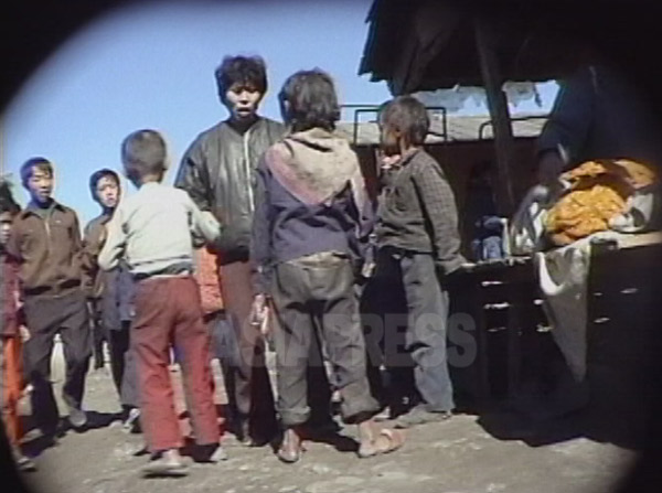 三人のコチェビが、商売の邪魔だと女性に罵られている。1999年9月咸鏡北道の茂山（ムサン）郡にて撮影キム・ホン（アジアプレス）