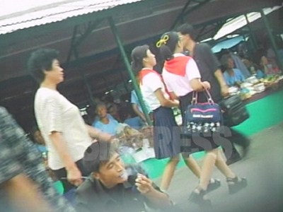 足元に注目。厚底サンダルで市場を闊歩する平壌の女子中学生。流行という外部情報も商品とともに入ってくる。07年8月、平壌市船橋市場。　（撮影：リ・ジュン）