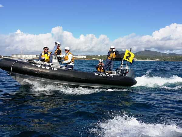 辺野古沖。基地建設反対を叫ぶ小型船やカヌーを追い立てる海上保安庁のゴムボート（2014年8月 栗原佳子撮影）