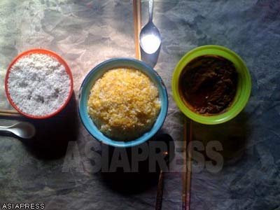 A typical meal: corn is supplemented with vegetables in a miso dressing (right) and salt (left). (March, 2011, Hyaesan, Ryanggang Province, by Choi Gyon-ok)