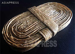 A coil of the dried "artificial meat" known asinjokogi. For the preparation of cooking, it should be steeped in water for about half an hour at least until it soaks up enough water and becomes soft. Our North Korean reporter Kim Dong-cheol smuggled it out to China in 2011.ASIAPRESS